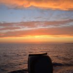 sunset on board a traditional Greek wooden boat